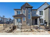 Modern two-story home featuring varied siding and a partially fenced front yard and newly installed landscape at 458 Millwall Cir, Castle Pines, CO 80108