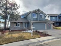 Charming two-story home with well-maintained lawn and two-car garage at 10941 Parker Vista Rd, Parker, CO 80138