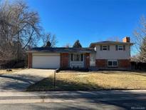 Ranch-style home with attached garage and a well-maintained lawn at 3079 S Galena Ct, Denver, CO 80231