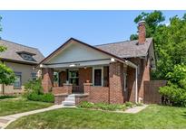 Charming brick home with a well-maintained front yard and a welcoming front porch with steps leading to the entrance at 4654 Bryant St, Denver, CO 80211