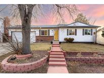 Charming single-story home featuring a tidy front yard, brick accents, and a welcoming red-brick walkway at 1811 S Norfolk St, Aurora, CO 80017
