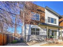 Modern home with a combination of wood and white siding, complemented by a well-maintained yard and a fence at 4035 Fenton Ct, Wheat Ridge, CO 80212