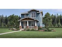 Charming two-story home with a welcoming front porch and beautifully landscaped front yard with grass and flowers at 920 Promenade Dr, Superior, CO 80027