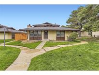 Charming home with a well-maintained front yard, a cozy exterior, and a welcoming pathway at 3827 S Fraser St, Aurora, CO 80014