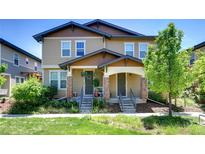 Charming townhome featuring a welcoming front porch and manicured landscaping in a desirable neighborhood at 3450 Valentia St, Denver, CO 80238