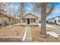 Charming home with a cozy front porch and a well-maintained yard at 1735 Dayton St, Aurora, CO 80010
