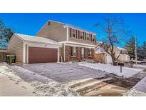 Two-story house with attached garage and snow-covered driveway at 16806 E Villanova Cir, Aurora, CO 80013