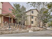 Exterior view of home with wood siding and a landscaped entrance at 325 Four O Clock Rd # 303, Breckenridge, CO 80424