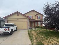 Two-story home with a two-car garage and a well-maintained lawn at 14874 E 52Nd Ave, Denver, CO 80239