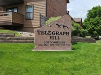 Telegraph Hill Condominiums sign surrounded by manicured lawn and building exterior at 7000 W 20Th Ave # 106, Lakewood, CO 80214