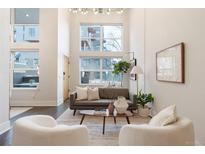 Bright living room features high ceilings, large windows, modern decor, and hardwood floors at 2506 16Th St, Denver, CO 80211