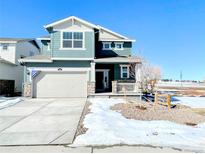 Two-story house with gray siding, attached garage, and small front yard at 241 Paloma Way, Elizabeth, CO 80107