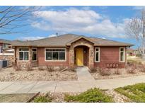 Charming single-story home with a stone-accented entryway and meticulously maintained landscaping at 8617 Gold Peak Dr # G, Highlands Ranch, CO 80130