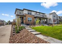 Charming two-story home with a blend of stone and siding, complemented by a well-manicured lawn at 4581 S Kipling Cir, Denver, CO 80123