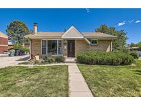Charming single-story brick home with a well-manicured lawn and a cozy front porch at 3531 E 91St Ave, Thornton, CO 80229