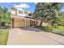Two story home with two-car garage and concrete driveway at 10627 Chautauga Mtn, Littleton, CO 80127
