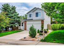 Charming two-story home with mature trees, a well-maintained lawn, and a two-car garage at 2940 E Yarrow Cir, Superior, CO 80027