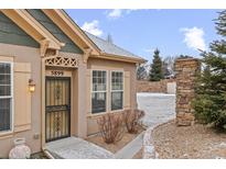 Charming single-Gathering home with a secure wrought iron front door and welcoming stone accents at 5899 S Taft Ter, Littleton, CO 80127