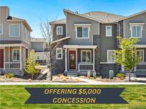 Charming two-story townhouse featuring stone accents, front porch and well-maintained landscaping at 23527 E 5Th Pl, Aurora, CO 80018