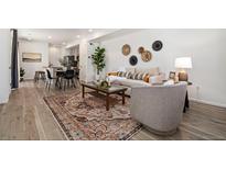 Inviting living room featuring modern decor, stylish furniture, and an open floor plan perfect for entertaining at 23527 E 5Th Pl, Aurora, CO 80018