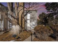 Townhouse exterior featuring landscaping and a tree in front at 8867 W Floyd Ave, Lakewood, CO 80227