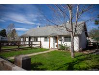 Charming home with a well-maintained front yard and a quaint wooden fence at 4087 S Clarkson S St, Englewood, CO 80113
