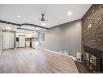 Bright living room with fireplace and laminate flooring at 14852 E Kentucky Dr # 928, Aurora, CO 80012