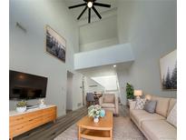 Bright living room featuring high ceilings, stylish decor, and a modern ceiling fan at 11113 E Alameda # 207, Aurora, CO 80012