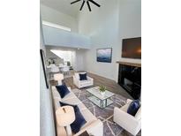 Bright living room with a fireplace, high ceilings, and modern furniture create an inviting atmosphere at 11113 E Alameda # 207, Aurora, CO 80014