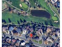 An aerial view shows the property's location on Quivas Way next to a golf course and a pond at 11351 Quivas Way, Denver, CO 80234
