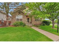 Charming stone-clad home with a well-manicured lawn and inviting walkway at 22834 E Davies Dr, Aurora, CO 80016