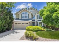 Inviting two-story home with a well-manicured front yard and a two-car garage at 9823 Salford Ln, Highlands Ranch, CO 80126