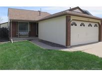 Charming single-story home featuring a well-manicured lawn and attached two car garage at 17671 E Brown Cir, Aurora, CO 80013