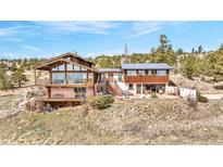 Stunning multi-story home featuring a combination of wood and stucco and multiple decks with a mountain view at 393 Dixon Rd, Boulder, CO 80302