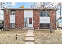 Charming two-story brick home featuring a well-manicured front yard and a welcoming entrance at 3310 W Mountain Rd, Englewood, CO 80110