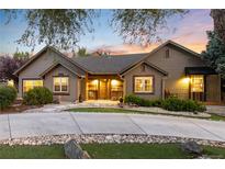 Charming single-story home featuring professional landscaping, decorative rock and inviting curb appeal at 1392 W Caley Ave, Littleton, CO 80120