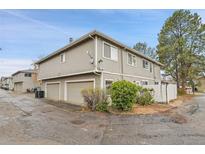 Charming townhome featuring a two-car garage and neutral gray siding, offering comfort and convenience at 1344 Sable Blvd, Aurora, CO 80011