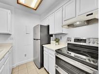 Bright kitchen features stainless steel appliances, ample cabinet space, and neutral countertops at 14751 E Tennessee Dr # 225, Aurora, CO 80012