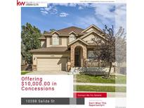 Two-story house with beige siding, brick accents, and a landscaped lawn at 10288 Salida St, Commerce City, CO 80022