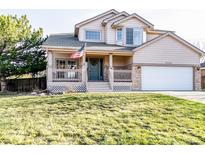 Charming two-story home with a covered front porch and well-maintained lawn, perfect for curb appeal at 17020 W 64Th Dr, Arvada, CO 80007