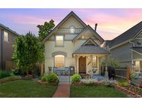Charming two-story home with a well-manicured front yard and cozy front porch seating area at 2829 N Franklin St, Denver, CO 80205