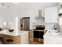 Bright kitchen featuring stainless steel appliances, white countertops, and light wood cabinets at 4264 Thorndyke Pl, Broomfield, CO 80020