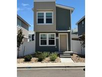 Charming two-story home with modern design, landscaped yard, and inviting front entrance at 5060 N Walden Way, Denver, CO 80249