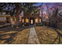 Charming two-story home with landscaped front yard, sidewalk and mature trees at 1250 Oneida St, Denver, CO 80220