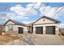 Charming ranch-style home with three-car garage, stone accents and solar panels at 14642 Sorrel Dr, Broomfield, CO 80023