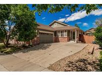 Charming single-Gathering home with a well-maintained lawn, a two-car garage, and lovely brick accents at 16257 E 105Th Cir, Commerce City, CO 80022