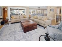 Spacious living room featuring comfortable sofas, a large area rug, and ample natural light at 7107 E Costilla Dr, Centennial, CO 80112