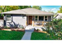 Gray craftsman home with a charming front porch and well-manicured lawn at 3061 S Grant St, Englewood, CO 80113