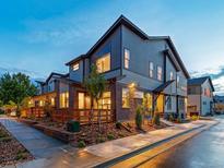 Modern two-story home with a mixed material facade and manicured front yard at 12319 W 58Th Ct, Arvada, CO 80004