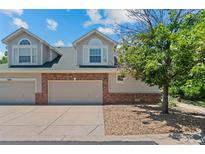 Charming townhome with a two-car garage and inviting curb appeal in a desirable neighborhood at 12502 E Harvard Cir, Aurora, CO 80014